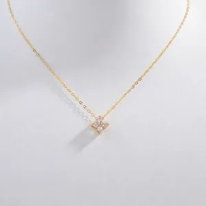 Macro shot of gold S925 silver four-leaf clover pendant necklace with shiny zircons