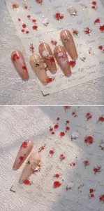 Macro shot of 3D rose nail art stickers with gold foil floral patterns and artistic text