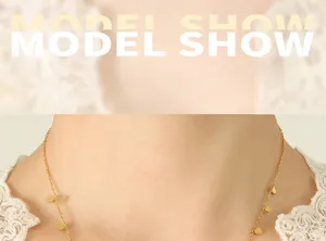 Close-up of 18K gold plated necklace with delicate leaf charms on model's neck