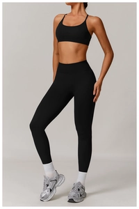 Full-body shot of a black high-waisted seamless yoga set and U-neck sports bra