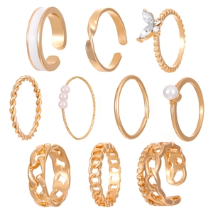 Detail of a 10-piece gold ring set featuring pearls, crystals, and butterfly charms