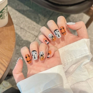 Halloween press-on nails with orange and black spooky hand-painted spider ghost designs