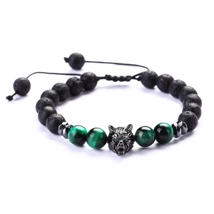 Detailed macro view of wolf head charm on adjustable lava stone and cat eye beaded bracelet
