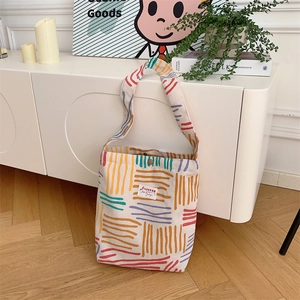 Macro detail of canvas stripe tote bag with corduroy texture in a lifestyle home setting