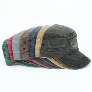 Macro detail of washed cotton cadet caps showing vintage textures and embroidery