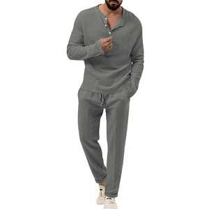 Detail of grey-green men's long sleeve henley top and drawstring trousers in cotton linen