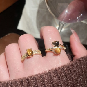 Detail of 18K gold plated tiger eye stone rings with micro-pave zircons on hand