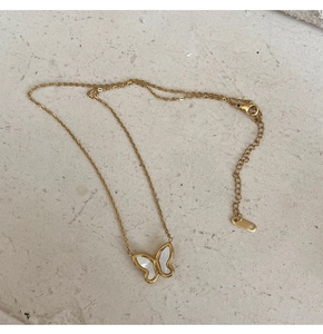 Close-up of golden butterfly necklace with white mother-of-pearl inlay and K18 clasp