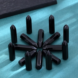 Radial arrangement of polished black obsidian hexagonal crystal pillars for healing