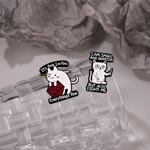 Dark style creative cat enamel pins with d20 dice and knife on textured glass background