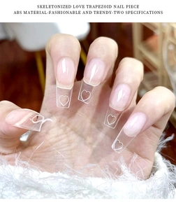 Macro view of clear trapezoid nail tips with heart-shaped cutout detail and ABS material