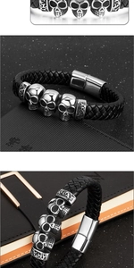 Macro shot of punk skull charms and black braided leather with silver magnetic clasp