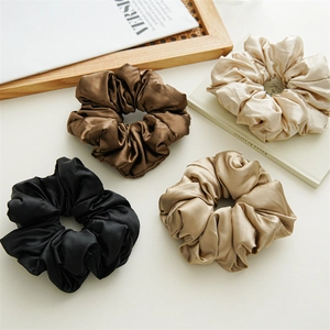 Set of four luxury satin oversized hair scrunchies in neutral colors for gentle hair styling