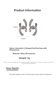 Macro shot of silver-tone rhinestone C-cross earrings with detailed size dimensions