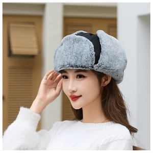Detailed view of gray faux fur lining and black windproof fabric on winter trapper hat
