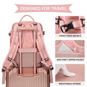 Pink travel backpack secured to a luggage handle featuring a breathable mesh back panel
