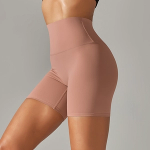 Detail of high-waist yoga shorts in dusty rose showing seamless wide waistband and texture
