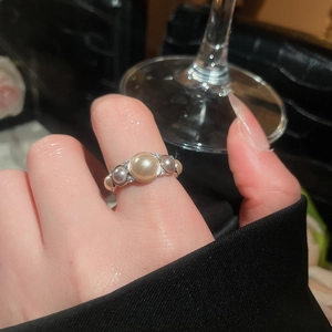 Detail of vintage French open ring featuring gold and gray pearls with zircon accents