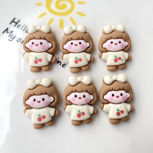 Close-up of six resin cartoon girl charms with cherry patterns for DIY phone case making