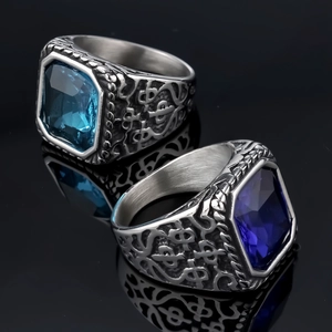 Macro shot of vintage steel rings with blue gemstones and engraved filigree details