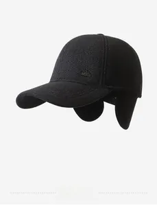 Close-up of winter men baseball cap featuring fold-down ear flaps and metal mountain logo