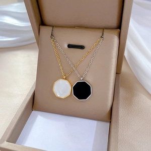 Minimalist titanium steel hexagonal shell necklace with gold plating in a jewelry box