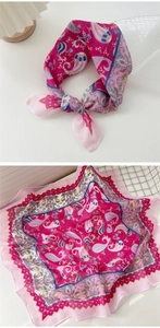 Detail of bohemian paisley cotton linen square scarf with pink fringe on white background