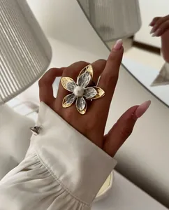 Detailed macro of two-tone flower ring with hammered texture and white pearl center