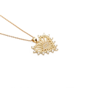 Detailed view of gold heart pendant necklace with evil eye design and white zircon stones
