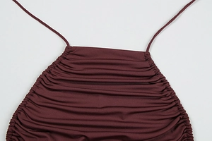 Close-up of ruched burgundy fabric detail with drawstring strap for summer top