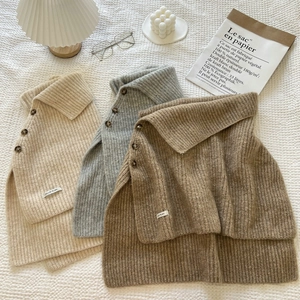 Detail of ribbed knit collar scarf with buttons in beige, grey and brown colors