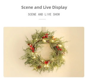 Close-up of artificial Christmas wreath with red berries, pine cones and warm LED lights