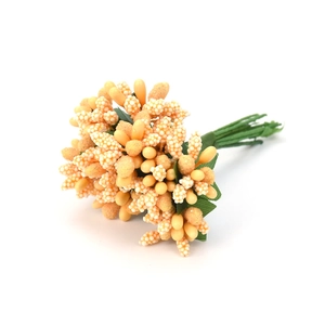 Detailed view of yellow and orange artificial berry stems for festive wreaths and boxes