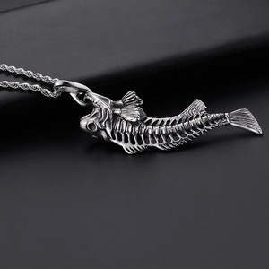 Detailed close-up of a silver shark bone pendant with a twisted chain on black leather