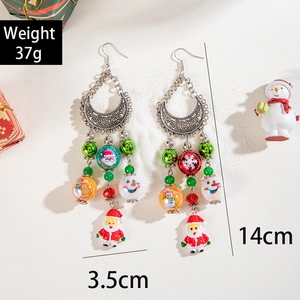 Ethnic beaded Santa tassel earrings with festive holiday beads on white background