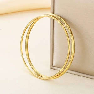 Set of two polished gold stainless steel stackable round wire bangles for women
