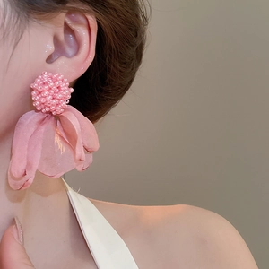 Detail of pink cluster flower earrings featuring beaded balls and soft tulle petals