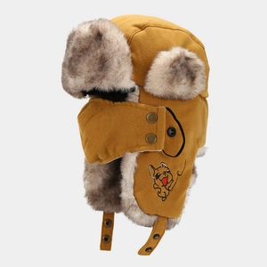 Detail of winter trapper hat with suede fabric, faux fur lining and dog embroidery