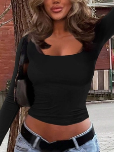 Slim fit black long sleeve U-neck top styled for women in a street urban background