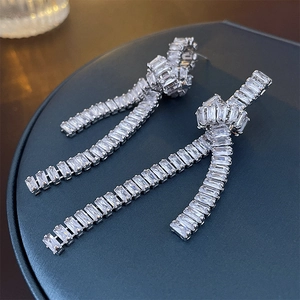 Elegant silver knot long tassel zircon earrings for women on a professional black background