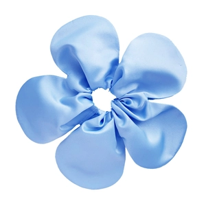 Light blue satin flower scrunchie with five glossy petals on a clean white background