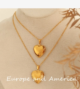 Detail of vintage heart locket necklaces on display with gold finish and engraving