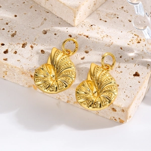Macro view of gold shell snail pendants with top rings for DIY jewelry making