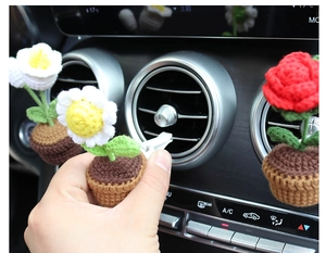 Crochet sunflower and rose car vent clips showing handmade texture and installation