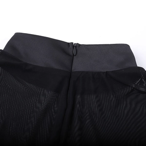Close-up of black mesh fabric with invisible zipper on elegant slim-fit dress