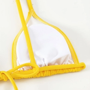 Bright yellow ribbed bikini top with breathable mesh lining and fine stitching detail
