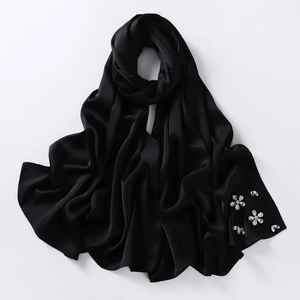 Detailed view of black bubble chiffon hijab with exquisite handcrafted rhinestone flowers