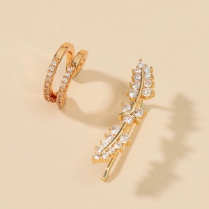 Detailed close-up of gold ear cuff set with rhinestone leaf design and micro inlay