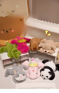 Group of seven small plush animals including crocodile and panda in lying poses
