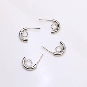 Macro shot of silver S925 C-shaped earring posts with small loop for DIY jewelry making